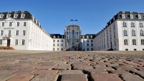 Blick aus der Bodenperspektive auf das Saarbrücker Schloss von vorne mit Pflastsersteine des Vorplatzes