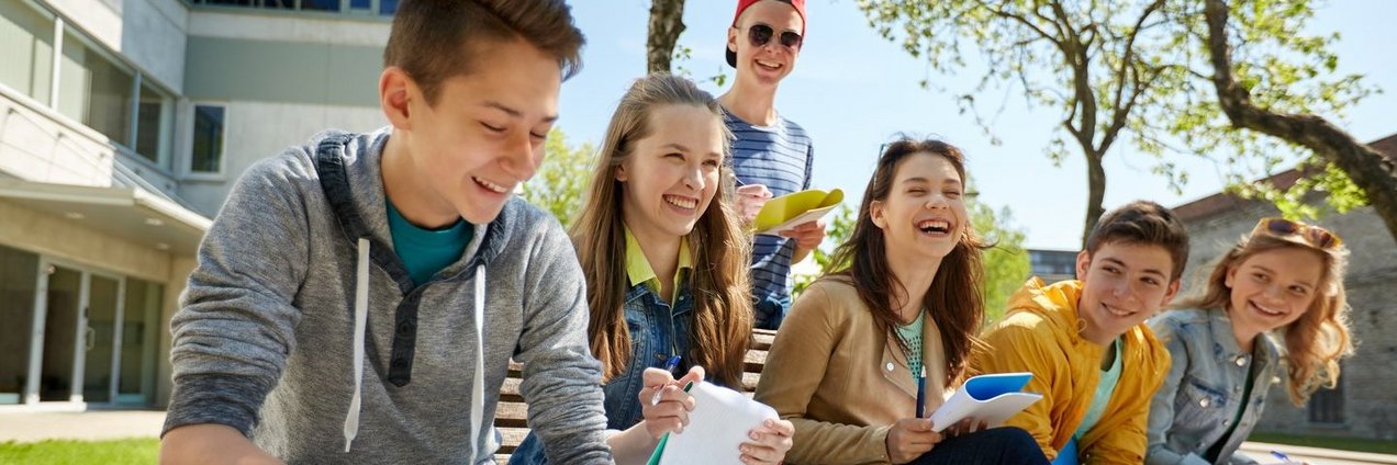 group of students with notebooks at school yard